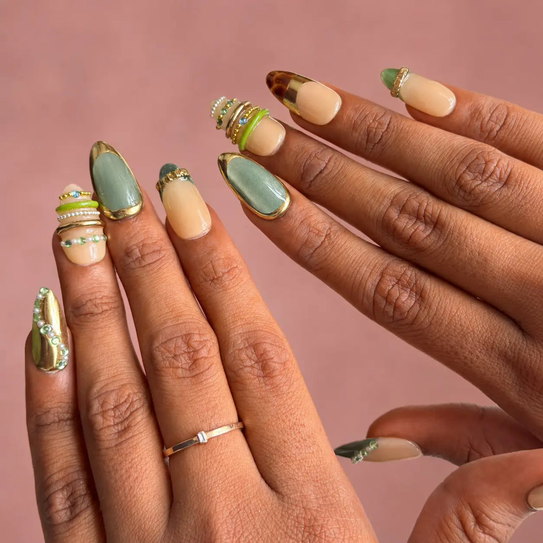 Set of tortoiseshell nail art designs in a clear case with decorative elements on a light background